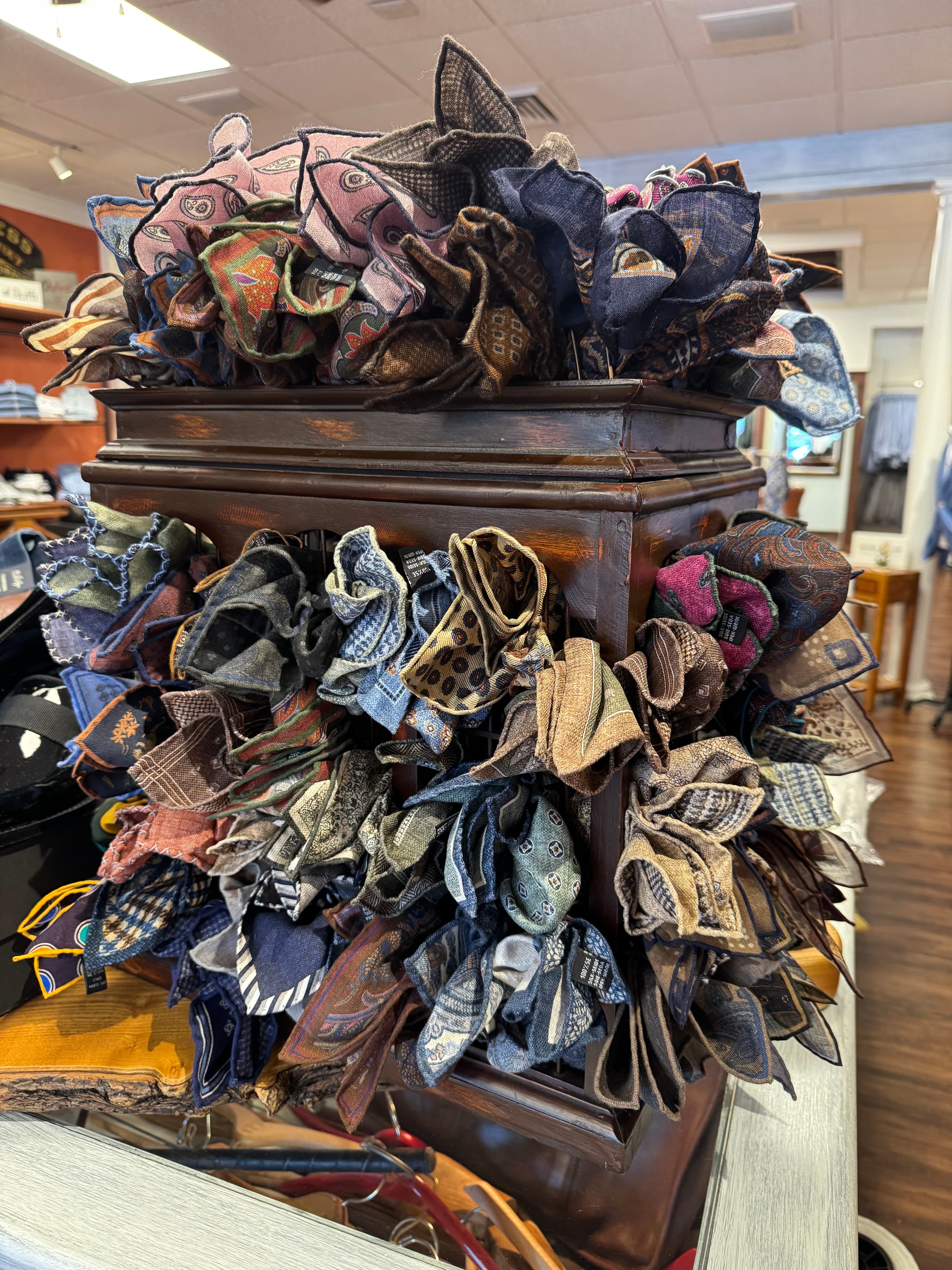 Warm luxurious menswear store interior with designer clothing displays